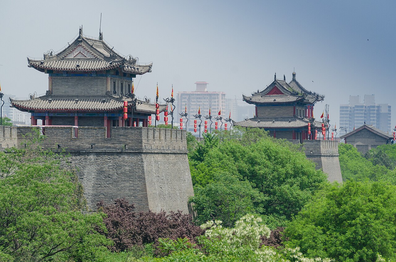 Ancient Ming Dynasty Xi’an City Wall watchtower and fortifications glowing at dusk
